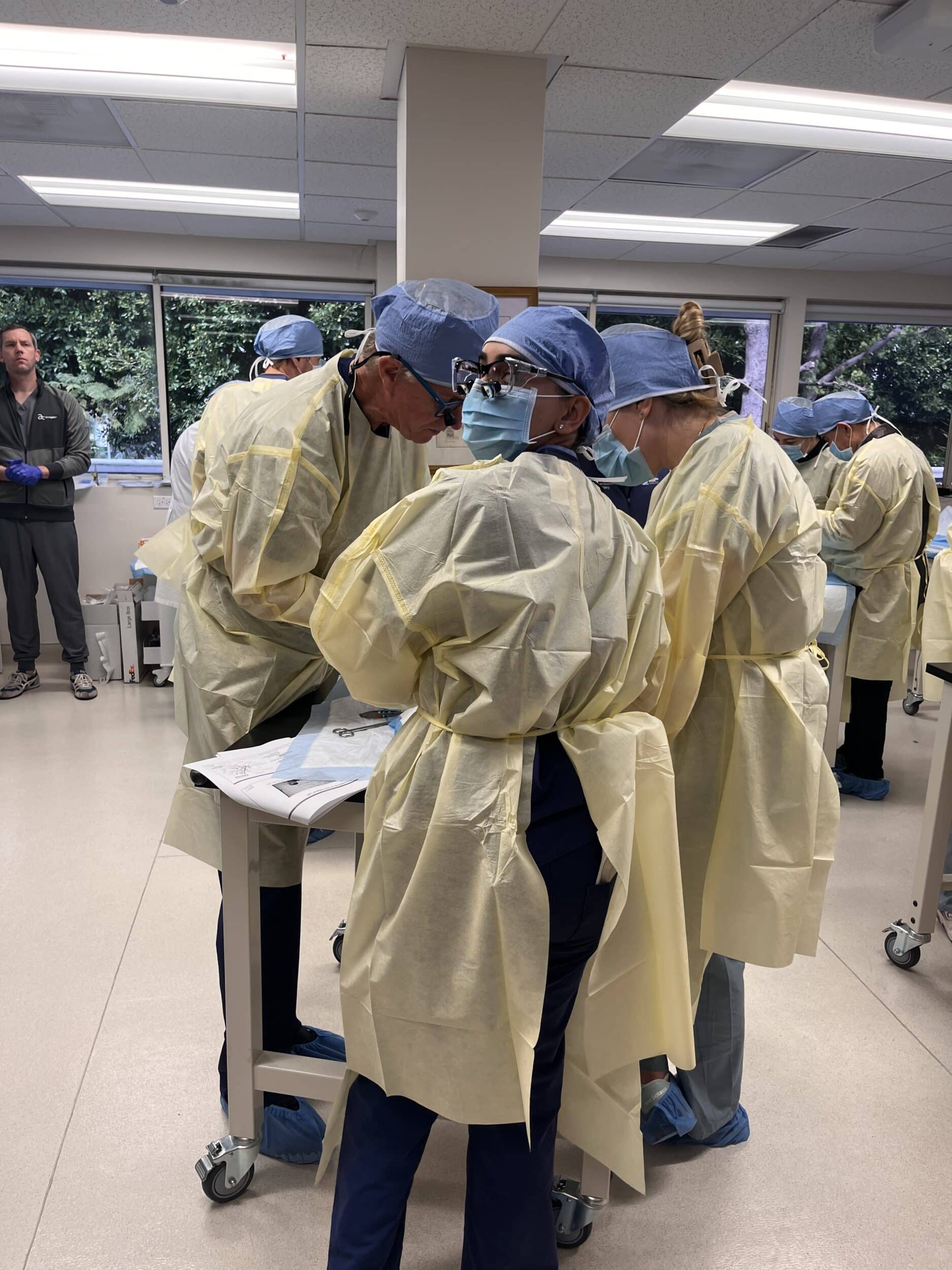 Attendees practicing their surgical skills at the cadaver lab.